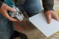 Man professional worker cutting tile with circular saw electric Royalty Free Stock Photo