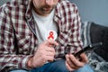 Man promotes healthy sexual relations, protected sex holding a condom while talking on video call with sexual partner Royalty Free Stock Photo