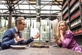 man proposing his girlfriend while she using smartphone with bored expression Royalty Free Stock Photo