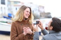 Man proposing marriage and girlfriend accepting