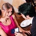 Man proposing to woman in restaurant Royalty Free Stock Photo