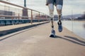 Man with prosthetic leg walking outdoor - Fitness and disability concept. Closeup. Generative AI Royalty Free Stock Photo