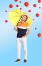 Man protecting himself from viruses with yellow umbrella as symbol of strong immunity