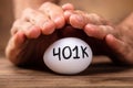 Man Protecting 401k White Egg