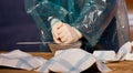 A man in a protective cloak with his gloves presses the juice into a glass plate Royalty Free Stock Photo