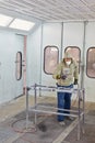 Man in protective clothes works in paint-spraying booth Royalty Free Stock Photo