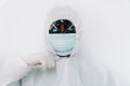 Man in protective coverall shows the mask with coronavirus. Conceptual portrait of a coronavirus