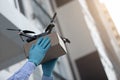 Man in protective gloves receiving drone with a delivery box