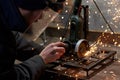 A man in a protective mask cuts metal on a machine tool