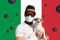 Man in protective mask and glasses with dog wearing face mask and abstract virus strain on Italian flag Royalty Free Stock Photo