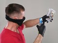 Man in protective mask and gloves spraying sanitizing spray on money to prevent virus and germs Royalty Free Stock Photo