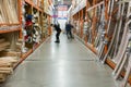 Man in a protective medical mask in a hardware store chooses boards. man is protected from the coronovirus. selected focus