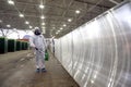 Man in protective suit is spraying, disinfection and decontamination on a public place as a prevention against Coronavirus, COVID