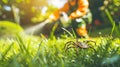 A man in a protective suit sprays the grass against ticks. Selective focus. Royalty Free Stock Photo
