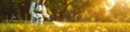 A man in a protective suit sprays the grass against ticks. Selective focus. Royalty Free Stock Photo