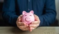 A man protects his savings. The piggy bank is in good hands. Savings and deposit banking. Wealth and prosperity. Healthy economy. Royalty Free Stock Photo