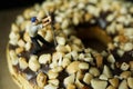a man is prying nuts on a donut