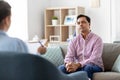 Man and psychologist at psychotherapy session Royalty Free Stock Photo