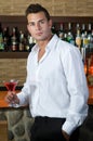 Man in a pub with red martini Royalty Free Stock Photo