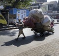Man pulling a heavy loaded cart, Mumbai Royalty Free Stock Photo