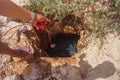 Man pulling out bucket of water from a well