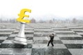 Man pulling pound symbol of money chess on chessboard Royalty Free Stock Photo