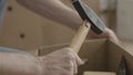 Man pulls a hammer out of the box. Man doing home renovations and pulls a hammer out of the box Royalty Free Stock Photo