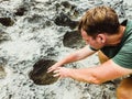 Man pulls his hands into mystic dark moon crater. Astrology, astronomy, paranormal activity concept or scary