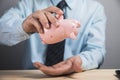 Takes money out of the piggy bank Royalty Free Stock Photo