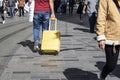 Man pulls yellow suitcase on the road. Trying to go somewhere. Royalty Free Stock Photo