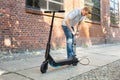 Man Pumping Air Into Tire On E-Scooter Royalty Free Stock Photo