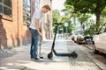Man Pumping Air Into Tire On E-Scooter Royalty Free Stock Photo