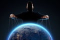 A man, a puppeteer, manipulates the planet. The concept of world conspiracy, world government, manipulation, world control