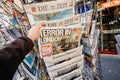 Man purchases Die Bild newspaper from press kiosk after London