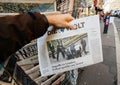 Man purchases Die Zeit newspaper from press kiosk after London a