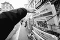 Man purchases a Financial times newspaper from press kiosk after