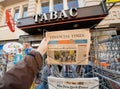 Man purchases a Financial times newspaper from press kiosk after