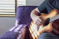 Closeup of man strumming guitar