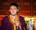 Young man holding a cobra snake.