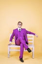 Man in Purple suit sitting on park bench