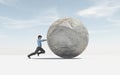 Man pushing a big sphere to the top. Success concept.