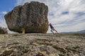 Man pushing a big stone