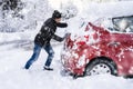 Man Pushing A Car Stuck In The Snow Royalty Free Stock Photo