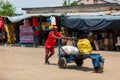 Man pushing cart with bags on street of Miandrivazo in Madagascar