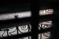 Man pushing a cart in Kotor, Montenegro, shot through half-open window shutters