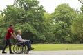 Man pushing disabled person on wheelchair Royalty Free Stock Photo