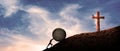 Man Pushing hardly A Big rock Up Hill in front of Jesus Christ cross. in panoramic landscape. hard worker, true believer in god