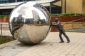Man pushing a huge ball