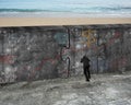 Man pushing huge puzzle door of business doodles concrete wall Royalty Free Stock Photo