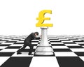 Man pushing money chess of golden pound currency Royalty Free Stock Photo